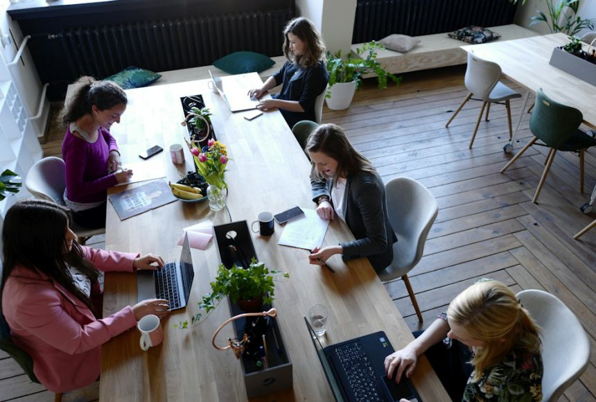 Consulting team comparing options around a meeting table