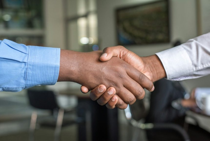 Advisor and client shaking hands at the close of a project review