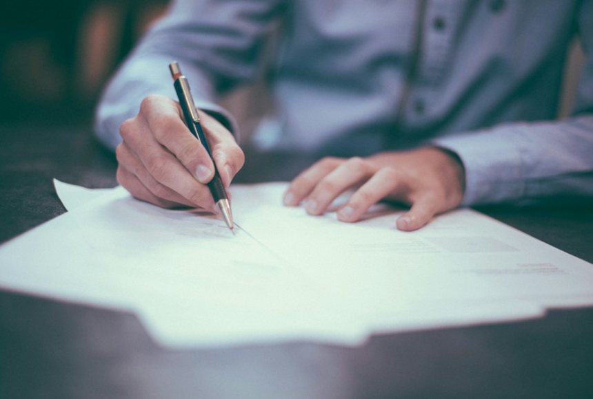 Signing a business contract at a meeting table